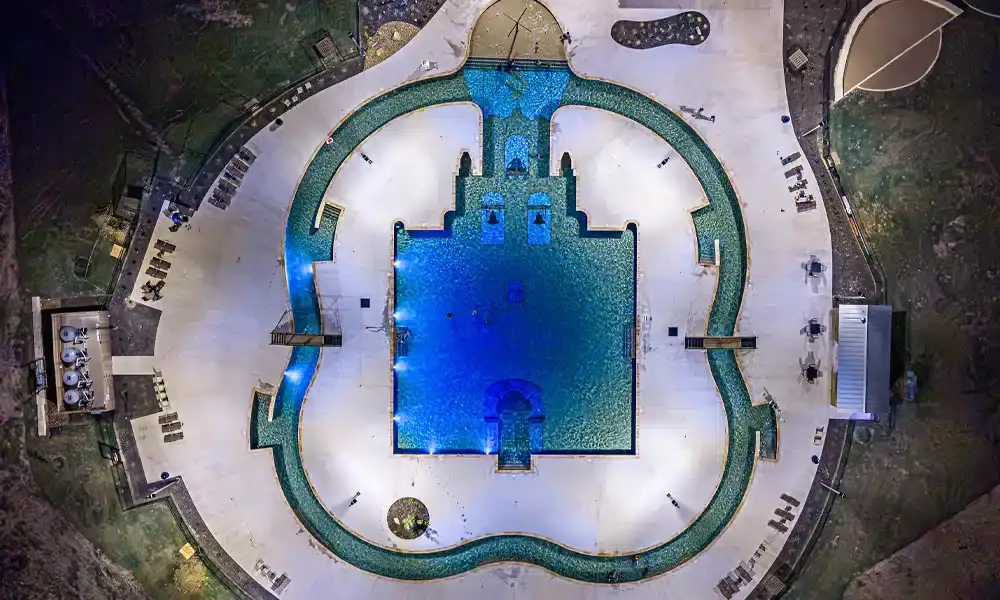 Espada-Amenity-Center-full-aerial-completed-pool-at-night-3cs-construction
